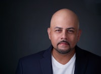 a bald man wearing a suit and white shirt